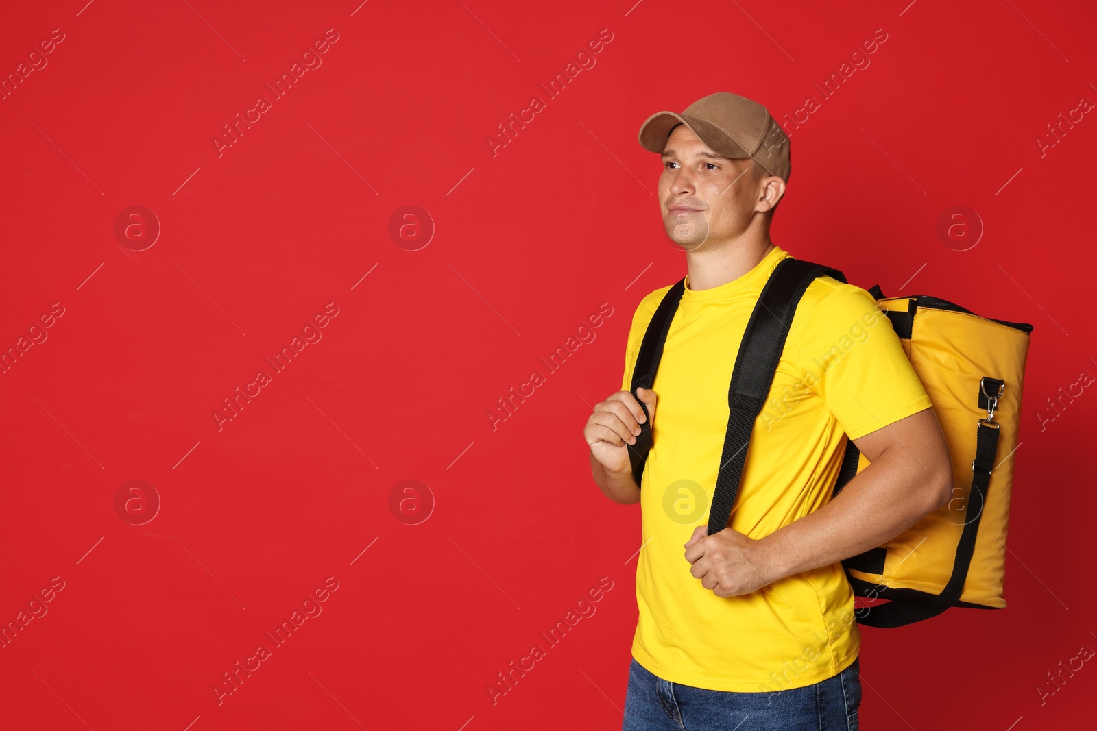 Courier with thermo bag on red background, space for text. Food delivery service Photo of Courier with thermo bag on red background, space for text. Food delivery service