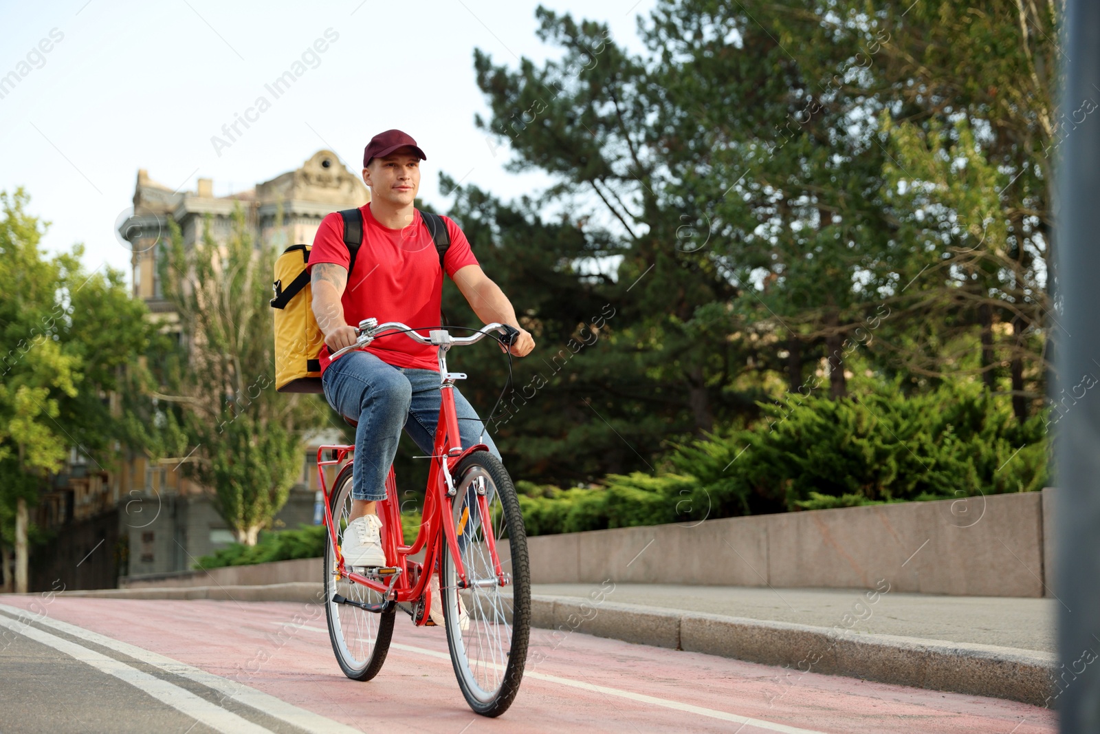 Courier with thermo bag riding bicycle outdoors, space for text. Food delivery service Photo of Courier with thermo bag riding bicycle outdoors, space for text. Food delivery service