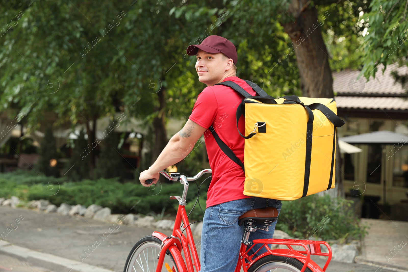 Courier with thermo bag riding bicycle outdoors, space for text. Food delivery service Photo of Courier with thermo bag riding bicycle outdoors, space for text. Food delivery service