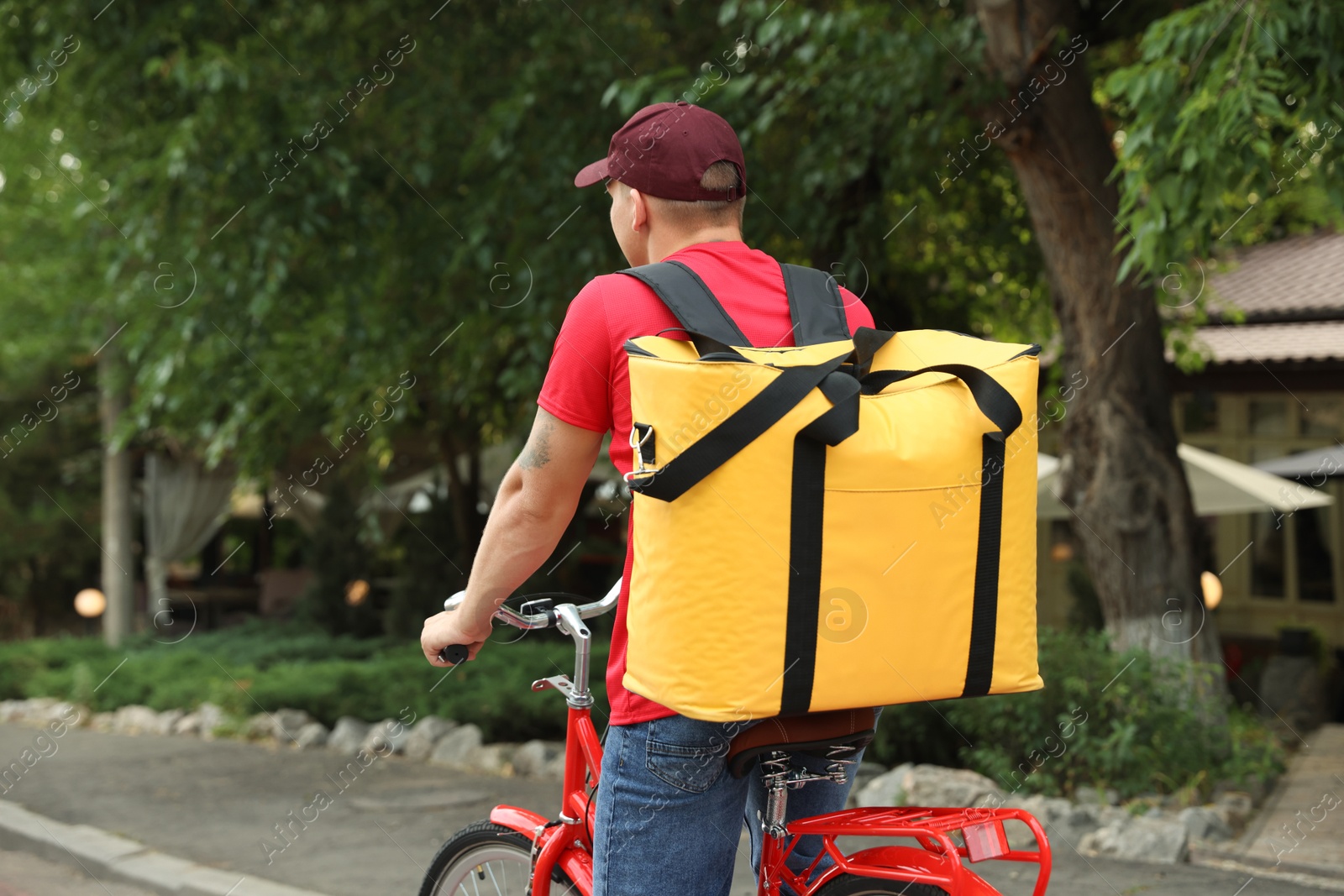 Courier with thermo bag riding bicycle outdoors, space for text. Food delivery service Photo of Courier with thermo bag riding bicycle outdoors, space for text. Food delivery service
