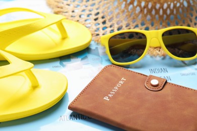 Photo of Time for summer vacation. Passport and beach accessories on world map, closeup