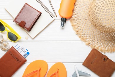 Photo of Time for summer vacation. Toy plane, passports, flight tickets, stationery and beach accessories on white wooden table, flat lay. Space for text