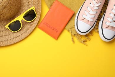 Photo of Time for summer vacation. Passport, shoes and beach accessories on yellow background, flat lay. Space for text