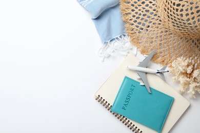 Photo of Time for summer vacation. Toy plane, passport, notebook and beach accessories on white background, flat lay. Space for text