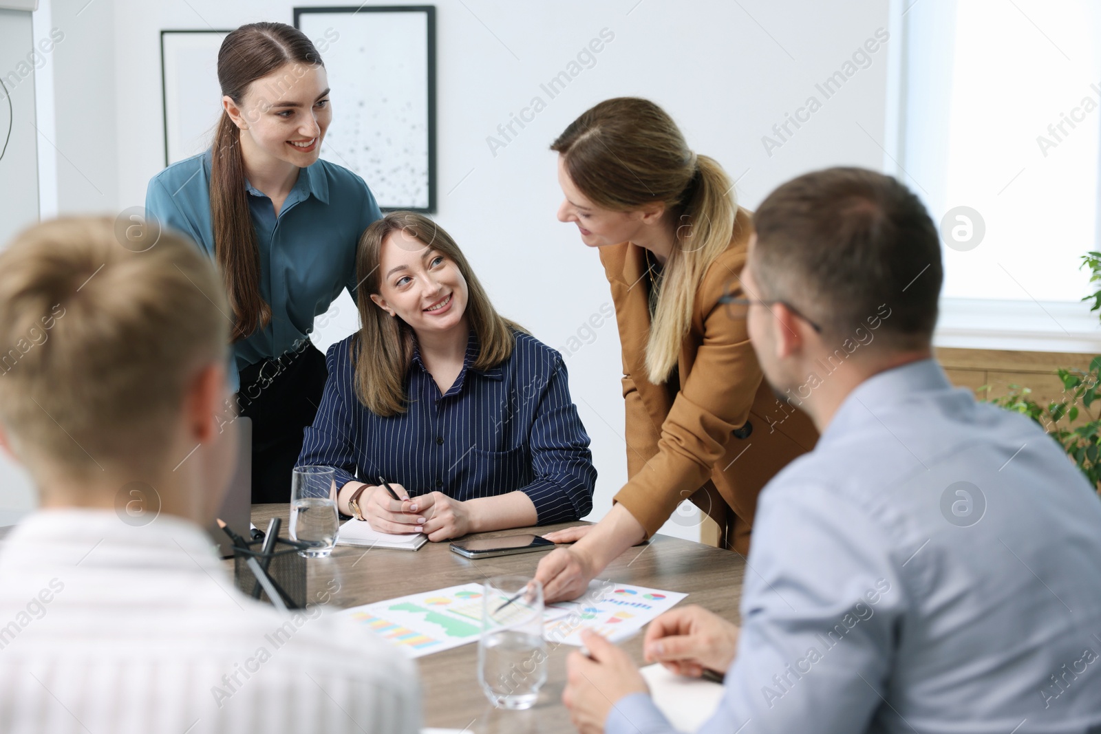 Business coach working with group of people in office Photo of Business coach working with group of people in office