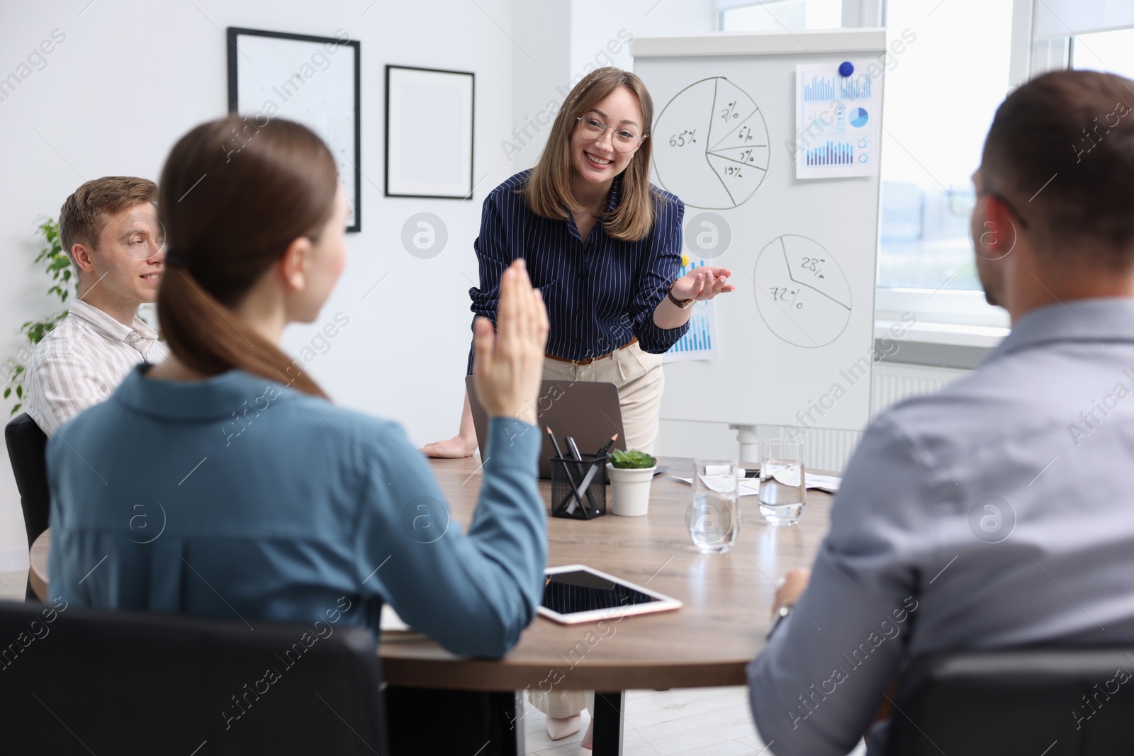 Business coach giving presentation to group of people in office Photo of Business coach giving presentation to group of people in office
