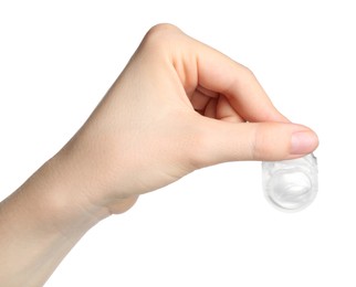 Photo of Woman holding blister pack with contact lens on white background, closeup
