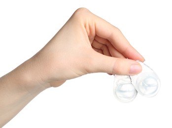 Photo of Woman holding blister packs with contact lenses on white background, closeup