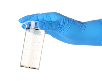 Photo of Scientist holding beaker with dirty water on white background, closeup