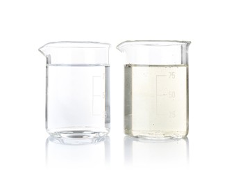 Photo of Glass beakers with clean and dirty water isolated on white