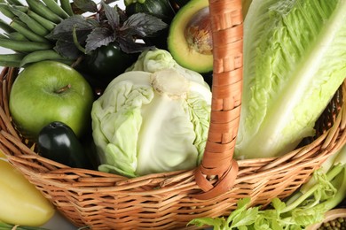 Photo of Superfood. Healthy food products in wicker basket on table, closeup