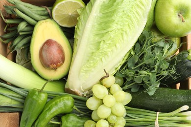 Photo of Superfood. Healthy food products in wooden crate, top view