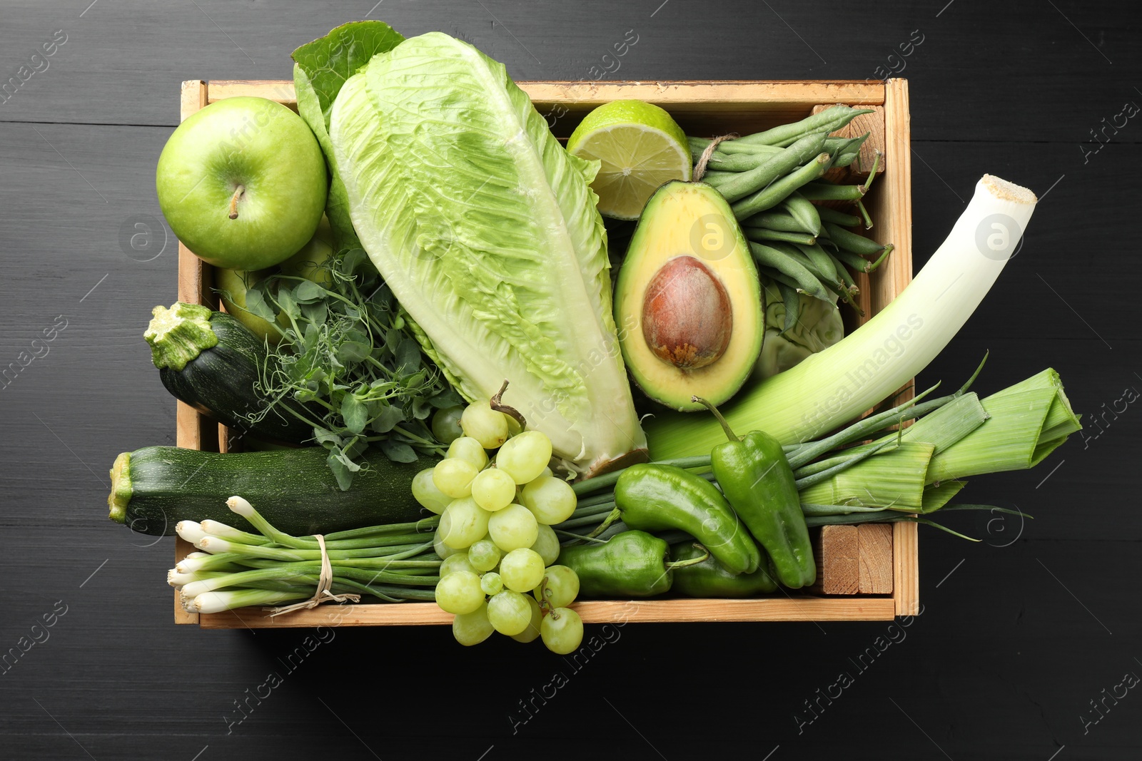 Superfood. Healthy food products in crate on black wooden table, top view Photo of Superfood. Healthy food products in crate on black wooden table, top view