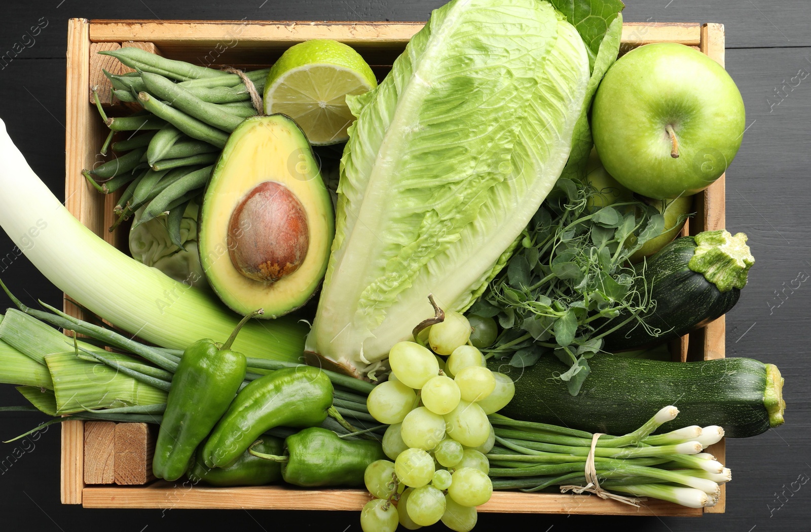 Superfood. Healthy food products in crate on black wooden table, top view Photo of Superfood. Healthy food products in crate on black wooden table, top view