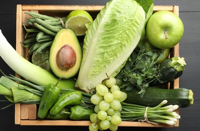 Photo of Superfood. Healthy food products in crate on black wooden table, top view