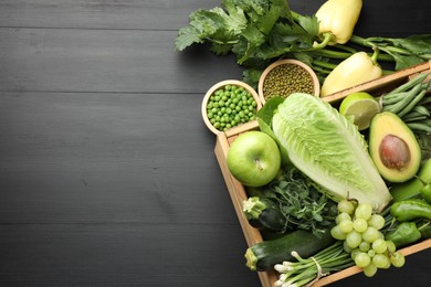 Photo of Superfood. Healthy food products on black wooden table, flat lay. Space for text