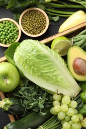 Photo of Superfood. Healthy food products on black wooden table, flat lay