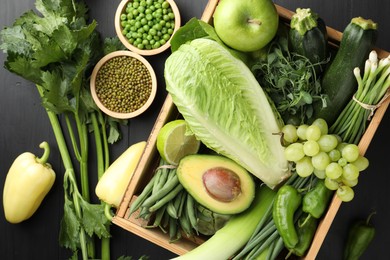 Photo of Superfood. Healthy food products on black wooden table, flat lay