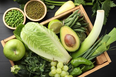 Photo of Superfood. Healthy food products on black wooden table, flat lay