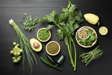 Photo of Superfood. Healthy food products on black wooden table, flat lay