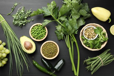 Photo of Superfood. Healthy food products on black wooden table, flat lay