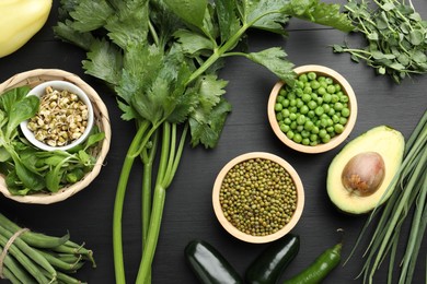 Photo of Superfood. Healthy food products on black wooden table, flat lay