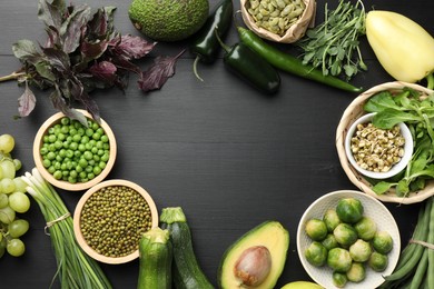 Photo of Superfood. Healthy food products on black wooden table, flat lay. Space for text