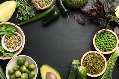 Photo of Superfood. Healthy food products on black wooden table, flat lay. Space for text