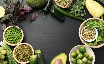 Photo of Superfood. Healthy food products on black wooden table, flat lay. Space for text