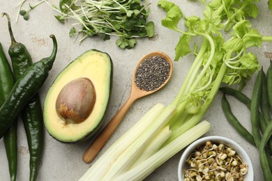 Photo of Superfood. Healthy food products on grey table, flat lay