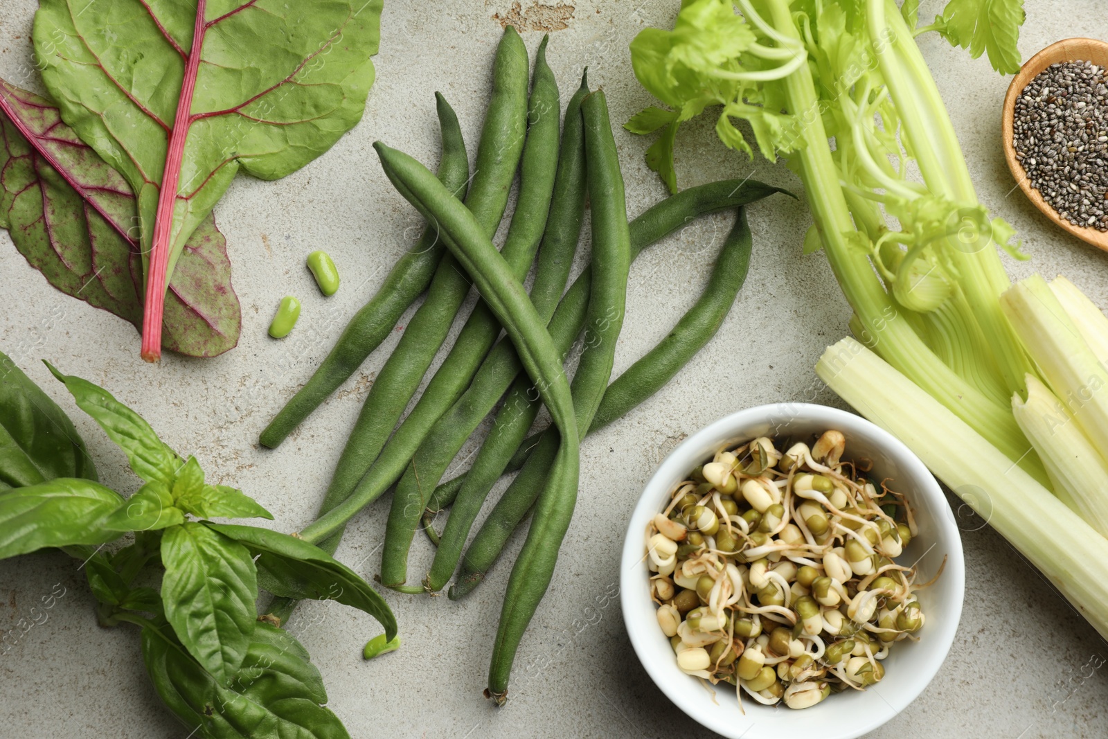 Photo of Superfood. Healthy food products on grey table, flat lay