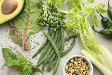 Photo of Superfood. Healthy food products on grey table, flat lay