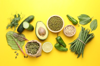 Photo of Superfood. Healthy food products on yellow background, flat lay