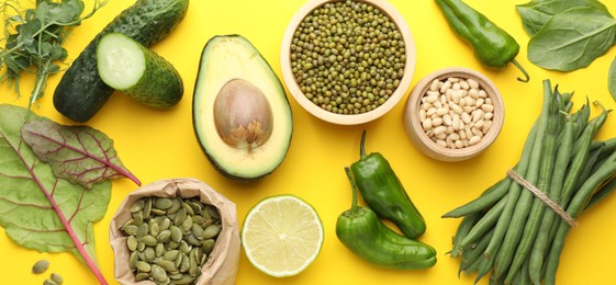 Photo of Superfood. Healthy food products on yellow background, flat lay