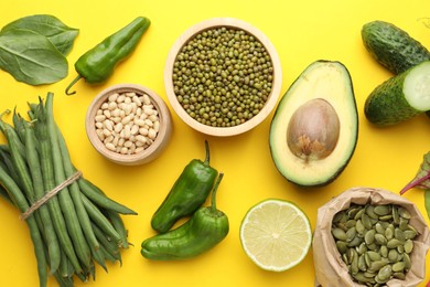 Photo of Superfood. Healthy food products on yellow background, flat lay