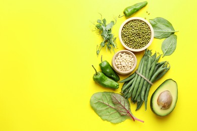 Photo of Superfood. Healthy food products on yellow background, flat lay. Space for text