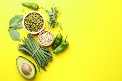Photo of Superfood. Healthy food products on yellow background, flat lay. Space for text