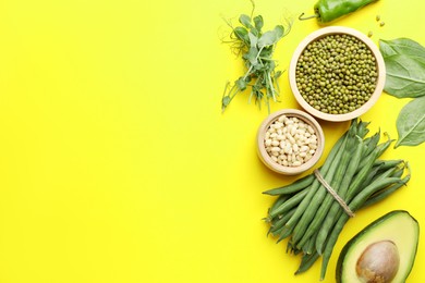 Photo of Superfood. Healthy food products on yellow background, flat lay. Space for text
