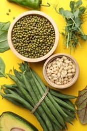 Photo of Superfood. Healthy food products on yellow background, flat lay