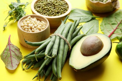Photo of Superfood. Healthy food products on yellow background, closeup