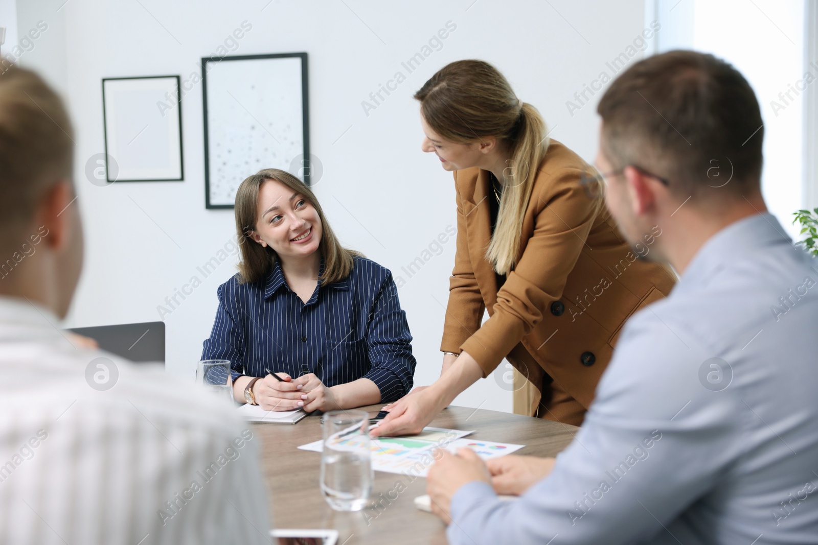 Business coach working with group of people in office Photo of Business coach working with group of people in office