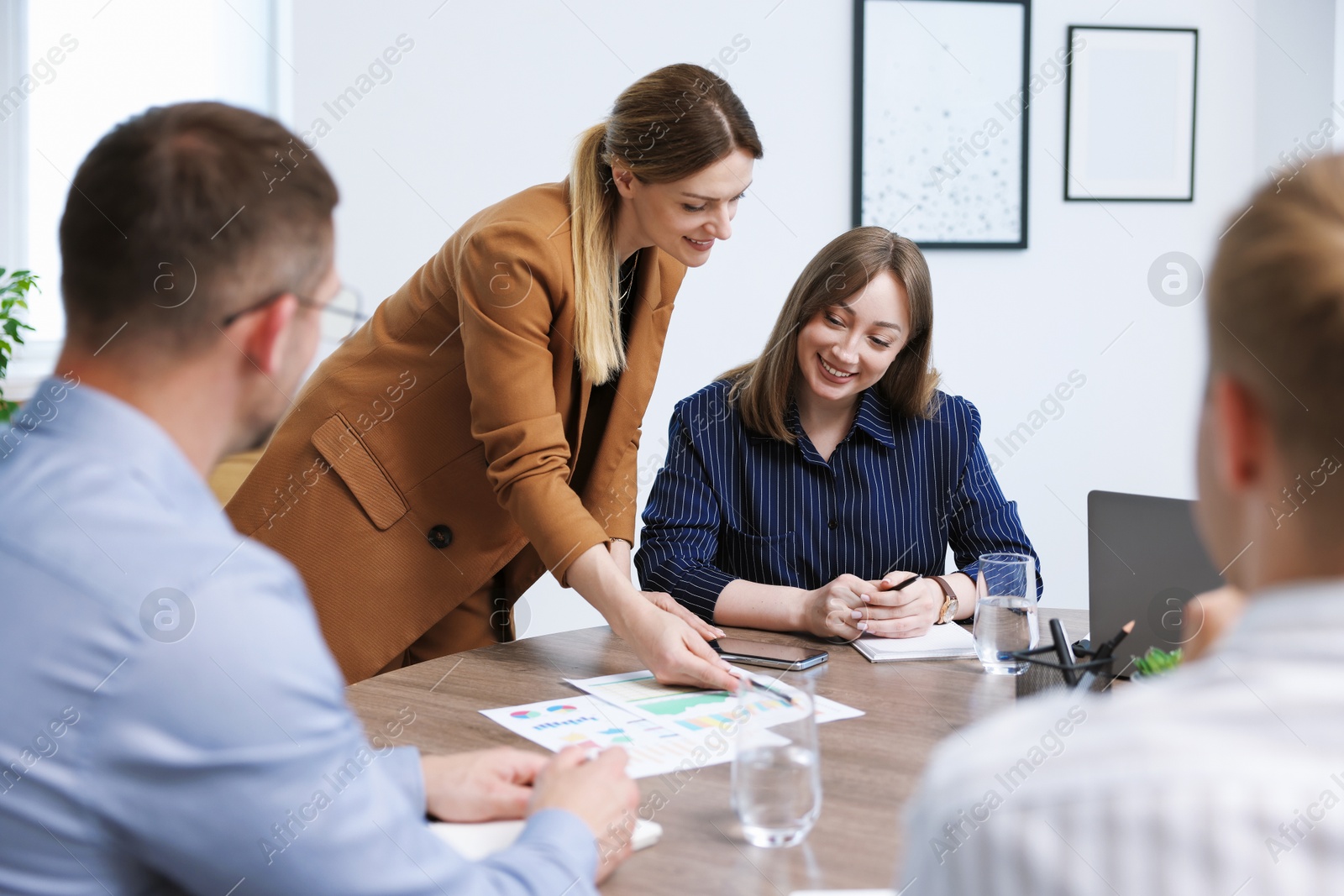 Business coach working with group of people in office Photo of Business coach working with group of people in office
