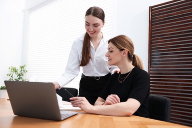 Photo of Business coach working with woman at wooden table in office
