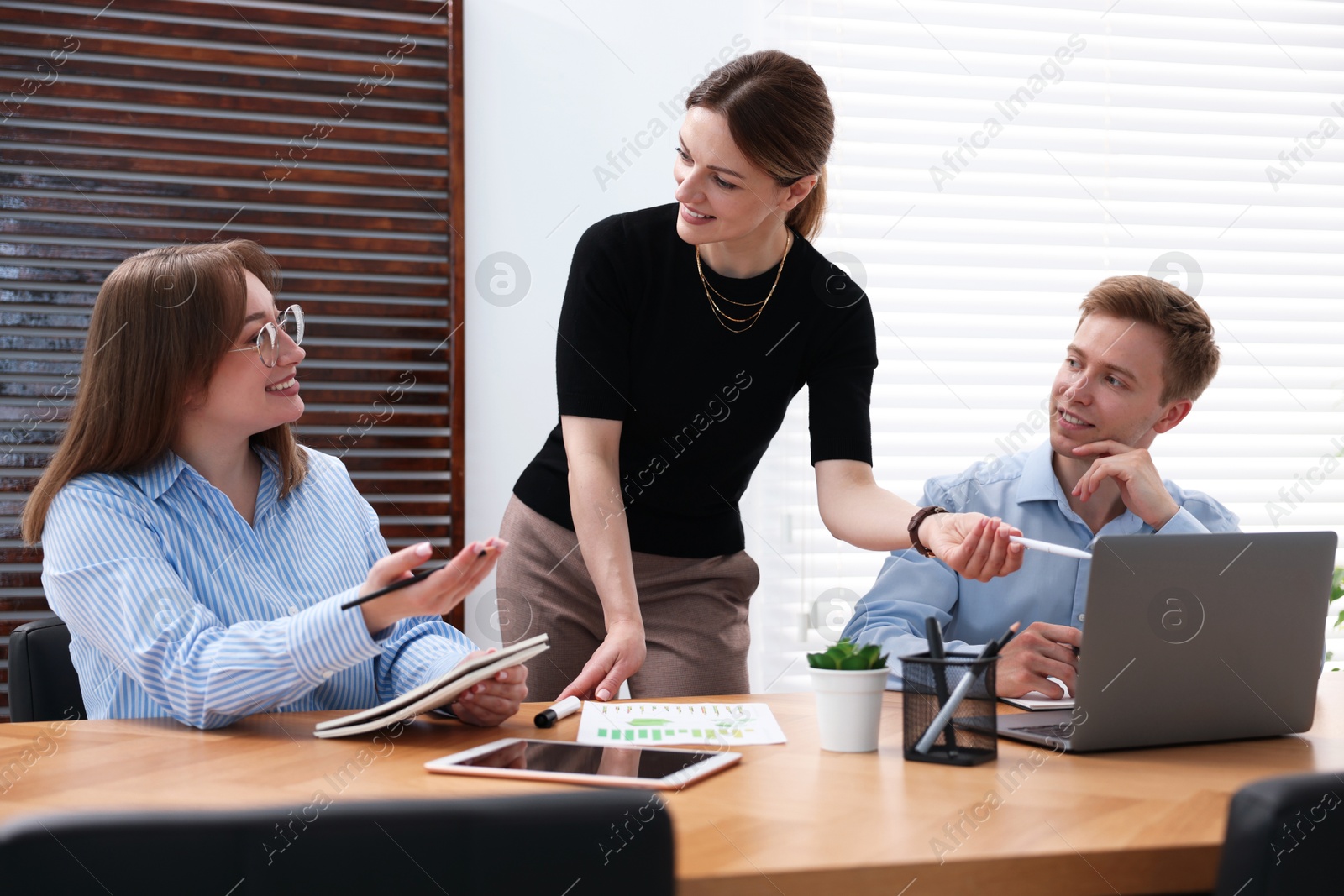 Business coach working with people in office Photo of Business coach working with people in office