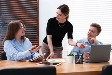 Photo of Business coach working with people in office