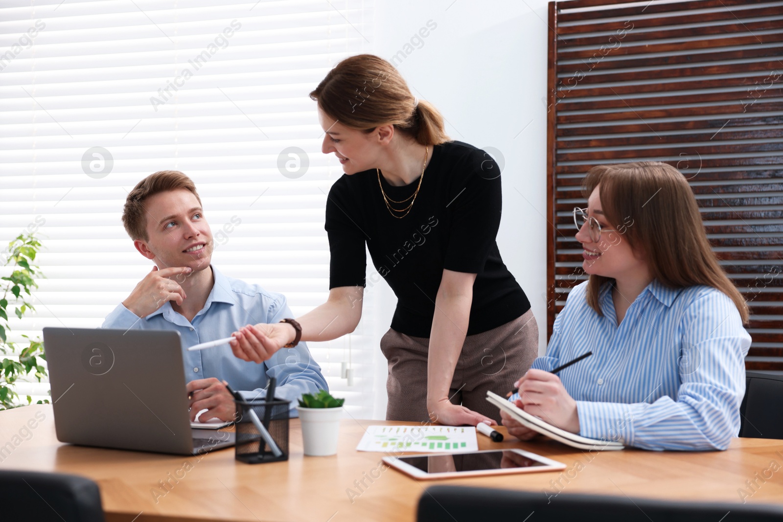 Business coach working with people in office Photo of Business coach working with people in office