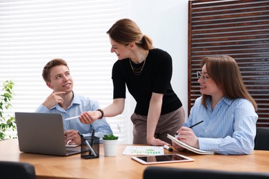 Photo of Business coach working with people in office