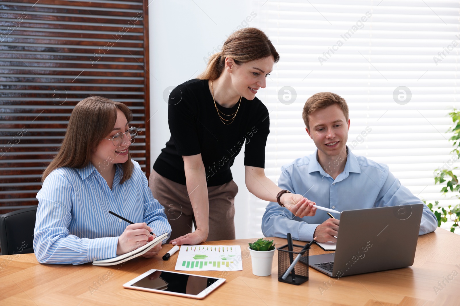 Business coach working with people in office Photo of Business coach working with people in office