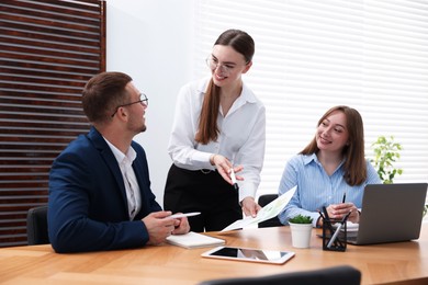 Photo of Business coach working with people in office