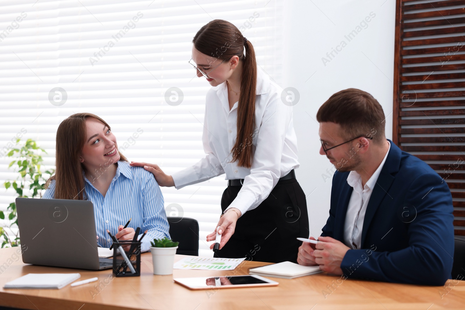 Business coach working with people in office Photo of Business coach working with people in office